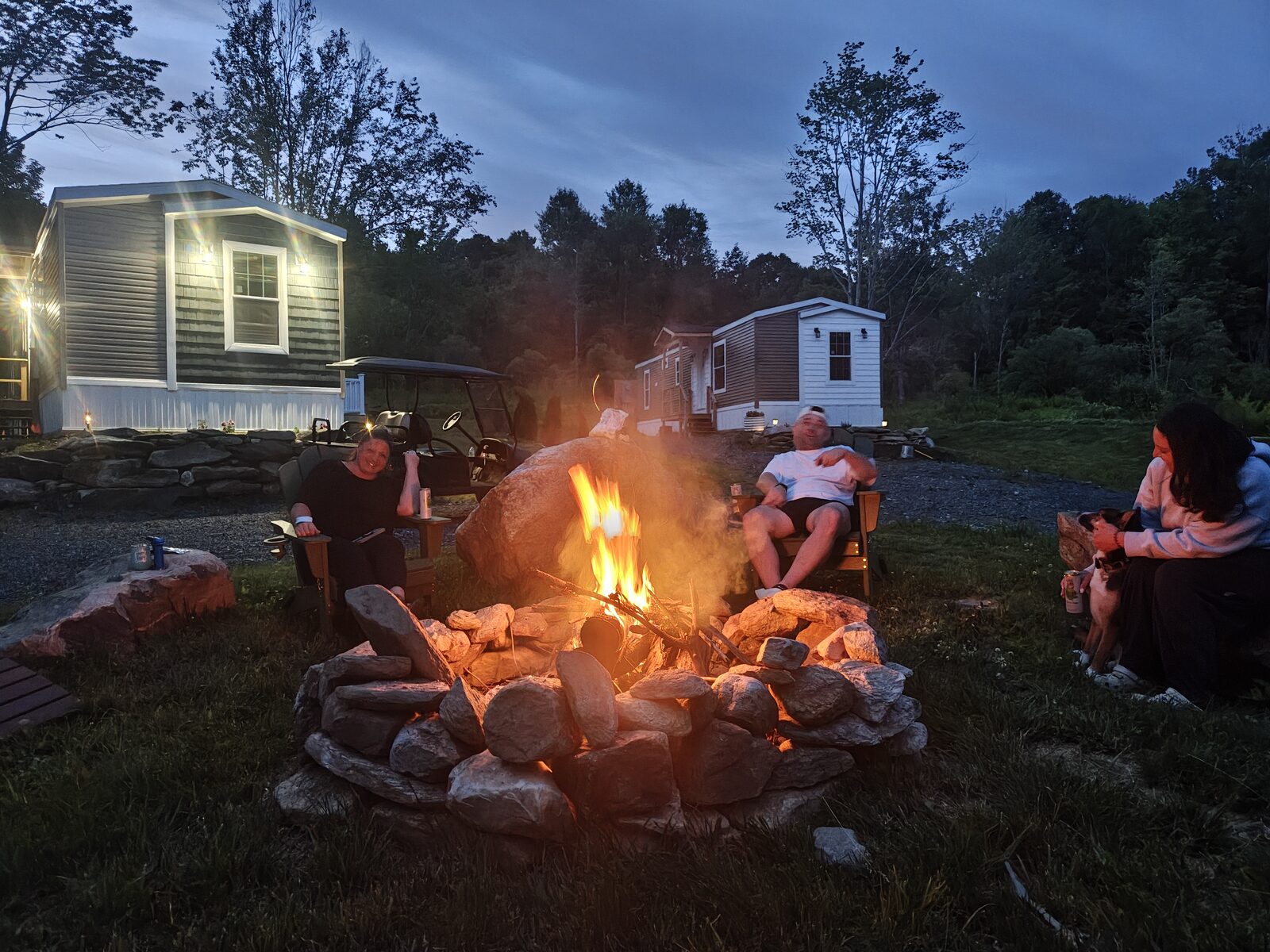 Guests gathered around the fire pit at dusk