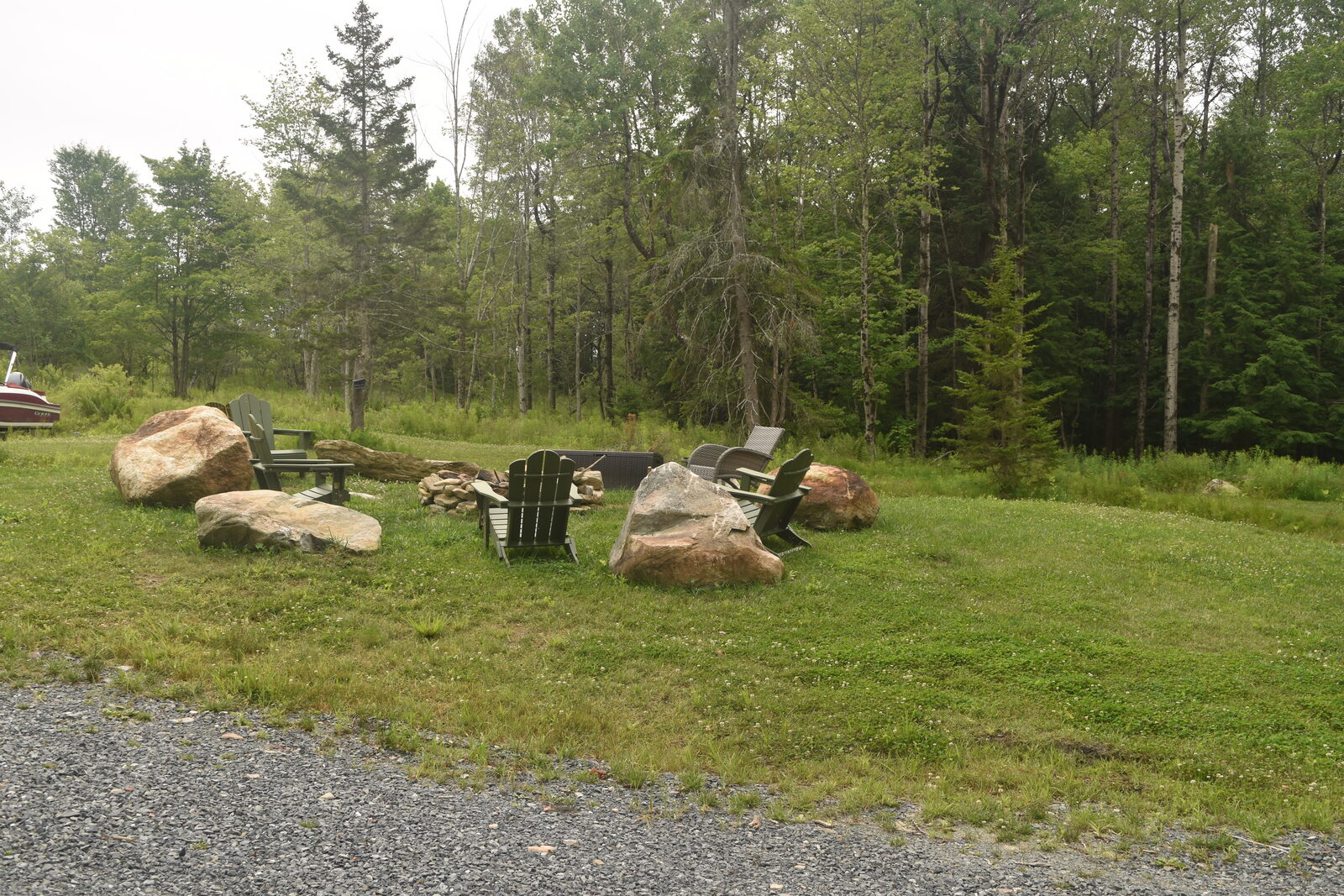 Fire pit with Adirondack chairs on the property