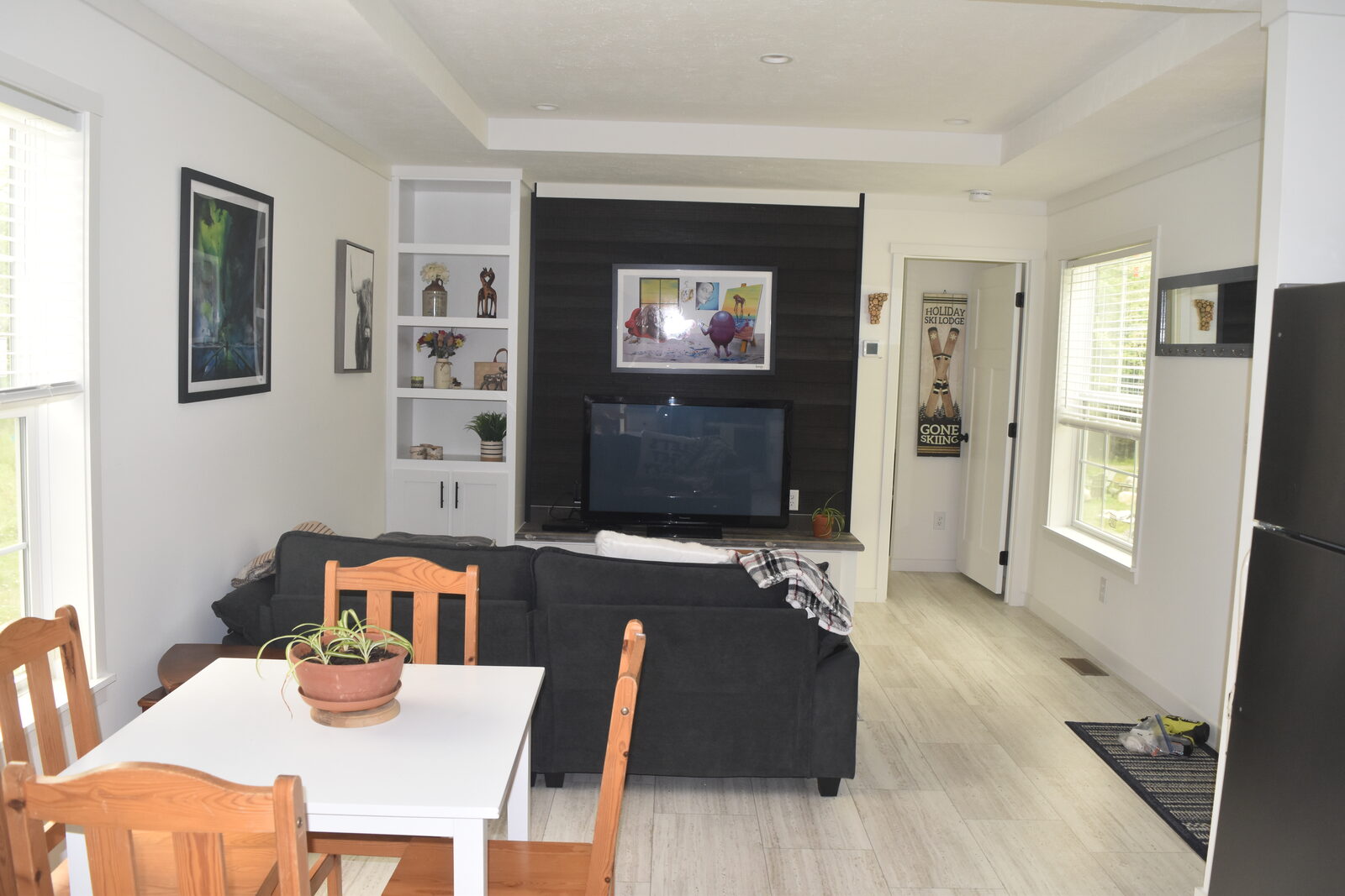 Unit B living room with TV and shelving